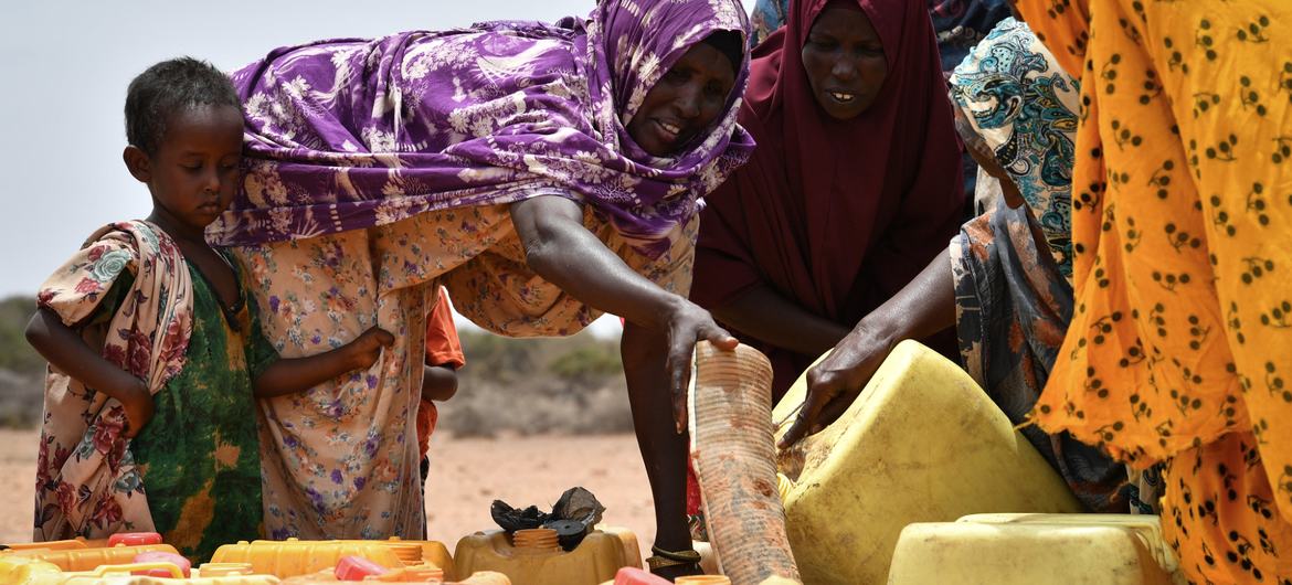 A group of women fetch water at a water trucking point in Kureyson village, Galkayo, Somalia.